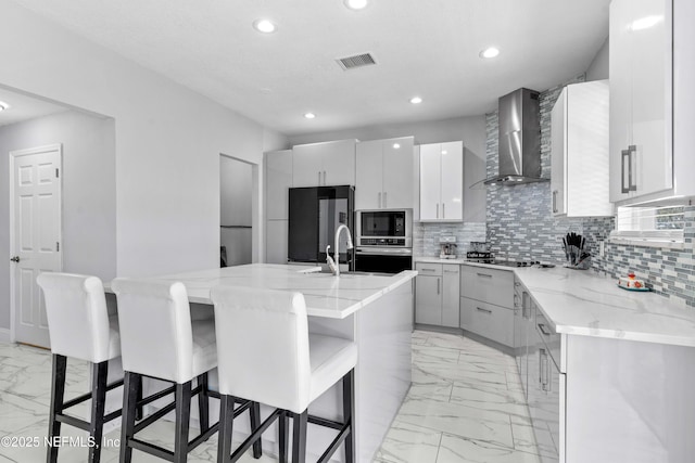 11 Reeding Ridge Dr W, Jacksonville, FL 32225 - kitchen with black microwave, fridge, marble finish floor, wall chimney exhaust hood, and a sink