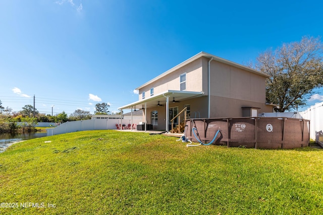 11 Reeding Ridge Dr W, Jacksonville, FL 32225 - rear view of property featuring a patio, a yard, a fenced backyard, and ceiling fan