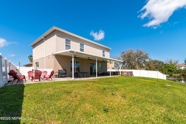 11 Reeding Ridge Dr W, Jacksonville, FL 32225 - rear view of house featuring ceiling fan, a lawn, stucco siding, a fenced backyard, and a patio area