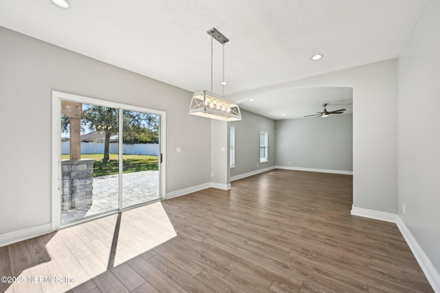 empty room with recessed lighting, baseboards, wood finished floors, and a ceiling fan