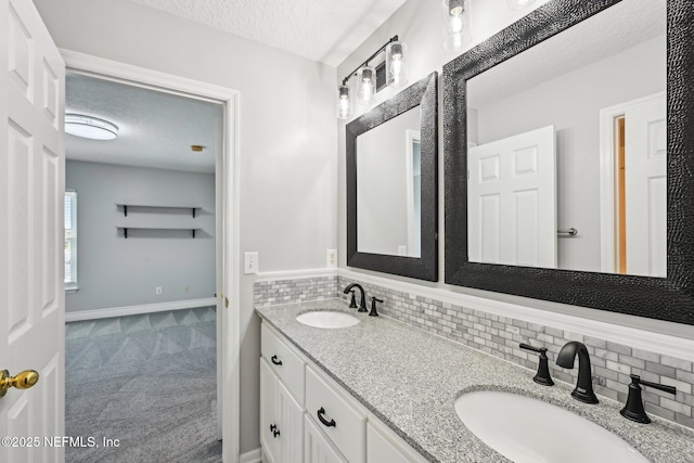bathroom featuring tasteful backsplash, a textured ceiling, and a sink