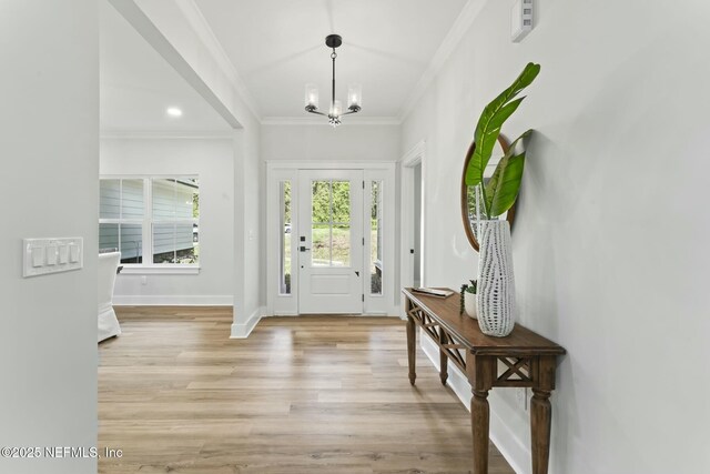 85172 Southern Creek Blvd, Fernandina Beach, FL 32034 - entryway featuring baseboards, a chandelier, ornamental molding, and light wood-type flooring