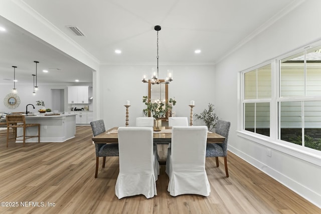 85172 Southern Creek Blvd, Fernandina Beach, FL 32034 - dining room featuring crown molding, an inviting chandelier, light wood-style flooring, recessed lighting, and visible vents