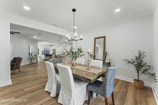 85172 Southern Creek Blvd, Fernandina Beach, FL 32034 - dining area with baseboards, ornamental molding, light wood finished floors, and ceiling fan with notable chandelier