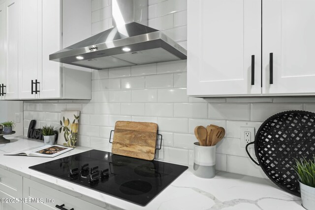 85172 Southern Creek Blvd, Fernandina Beach, FL 32034 - kitchen featuring black electric cooktop, light stone countertops, white cabinetry, and wall chimney exhaust hood