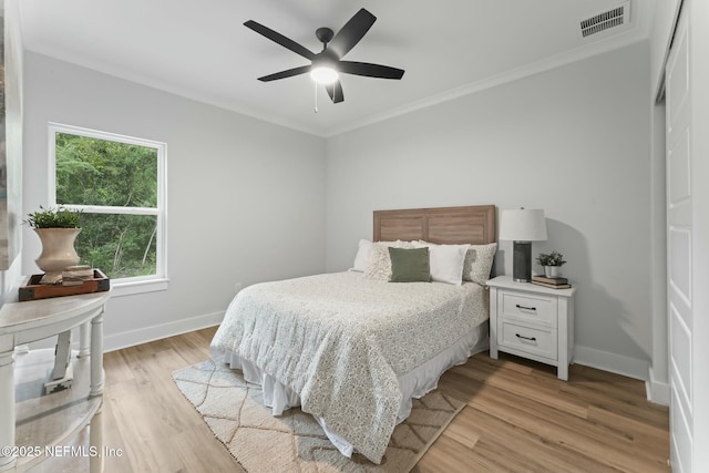 85172 Southern Creek Blvd, Fernandina Beach, FL 32034 - bedroom featuring visible vents, crown molding, baseboards, light wood-style floors, and ceiling fan