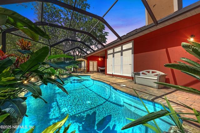 5266 Camelot Forest Dr, Jacksonville, FL 32258 - pool at dusk with an outdoor pool, a ceiling fan, a patio, a lanai, and french doors