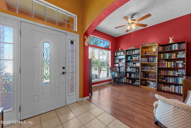 5266 Camelot Forest Dr, Jacksonville, FL 32258 - tiled entrance foyer with ceiling fan, arched walkways, baseboards, and a textured ceiling