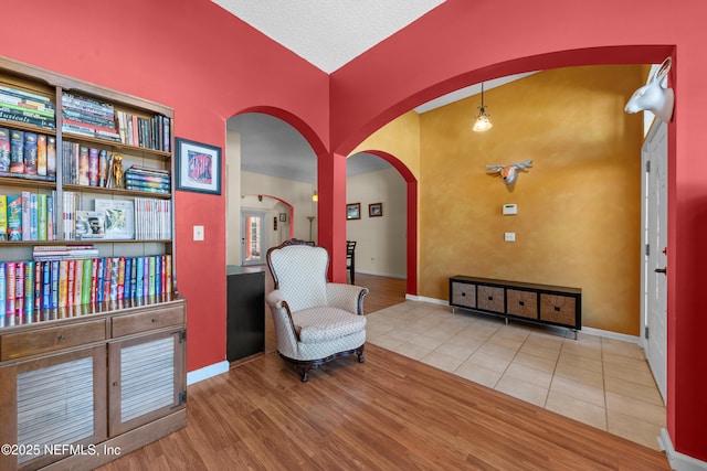 5266 Camelot Forest Dr, Jacksonville, FL 32258 - sitting room with arched walkways, baseboards, and tile patterned floors