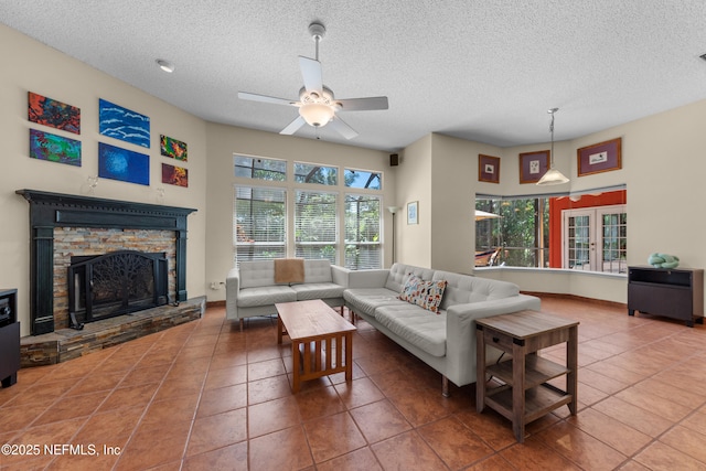 5266 Camelot Forest Dr, Jacksonville, FL 32258 - tiled living area with a stone fireplace, ceiling fan, baseboards, and a textured ceiling