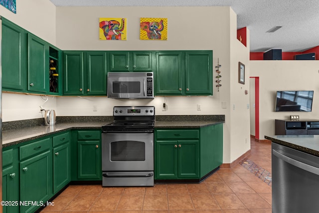 5266 Camelot Forest Dr, Jacksonville, FL 32258 - kitchen featuring light tile patterned floors, appliances with stainless steel finishes, visible vents, and a textured ceiling