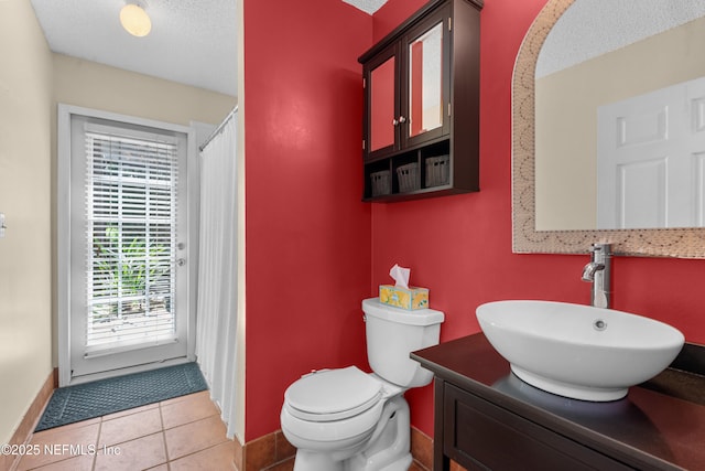 5266 Camelot Forest Dr, Jacksonville, FL 32258 - bathroom with vanity, baseboards, tile patterned floors, a textured ceiling, and toilet