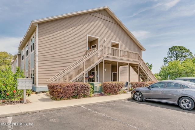 1601 Nectarine St Unit D5, Fernandina Beach, FL 32034 - view of property exterior with stairway, uncovered parking, and mail area
