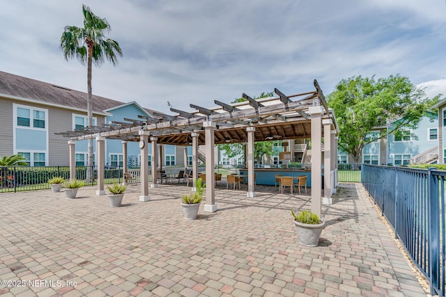 1601 Nectarine St Unit D5, Fernandina Beach, FL 32034 - view of patio with a fenced backyard, a pergola, and outdoor dining area