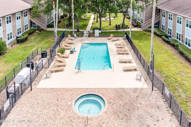 1601 Nectarine St Unit D5, Fernandina Beach, FL 32034 - community pool featuring a community hot tub, a lawn, and fence