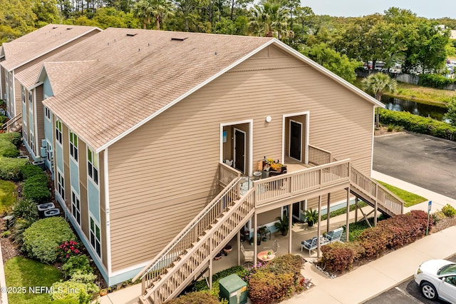 1601 Nectarine St Unit D5, Fernandina Beach, FL 32034 - back of property featuring a patio area, roof with shingles, stairs, and a deck