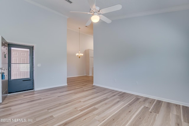 1601 Nectarine St Unit D5, Fernandina Beach, FL 32034 - spare room with baseboards, visible vents, light wood-style floors, ceiling fan with notable chandelier, and crown molding