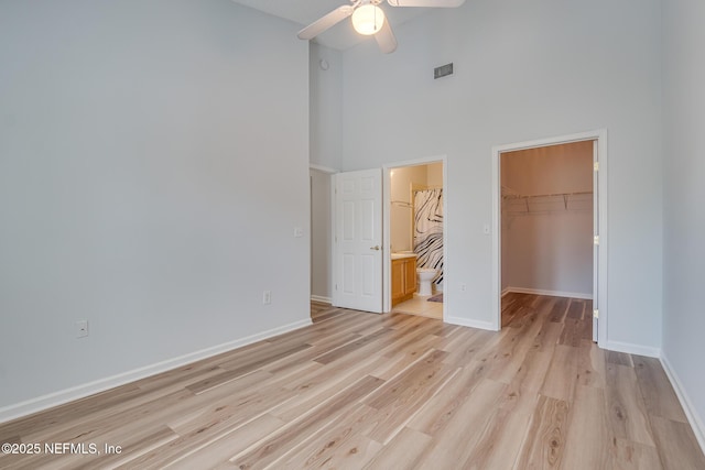 1601 Nectarine St Unit D5, Fernandina Beach, FL 32034 - unfurnished bedroom featuring a spacious closet, a towering ceiling, visible vents, light wood-type flooring, and a closet