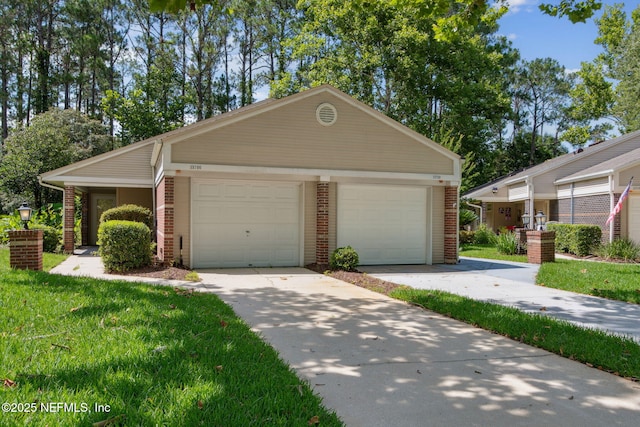 13706 Wm Davis Pkwy, Jacksonville, FL 32224 - view of front of house with brick siding, concrete driveway, and a front yard