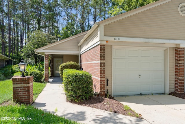 13706 Wm Davis Pkwy, Jacksonville, FL 32224 - view of property exterior featuring brick siding, driveway, and an attached garage