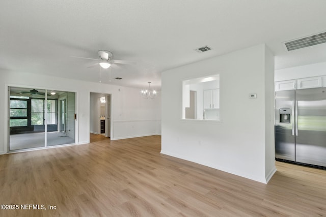 13706 Wm Davis Pkwy, Jacksonville, FL 32224 - unfurnished living room with a ceiling fan, light wood finished floors, and a chandelier