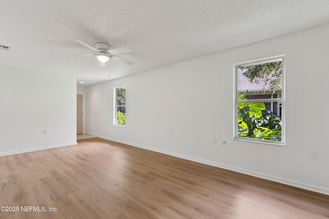 13706 Wm Davis Pkwy, Jacksonville, FL 32224 - spare room featuring light wood-style flooring, ceiling fan, and a textured ceiling
