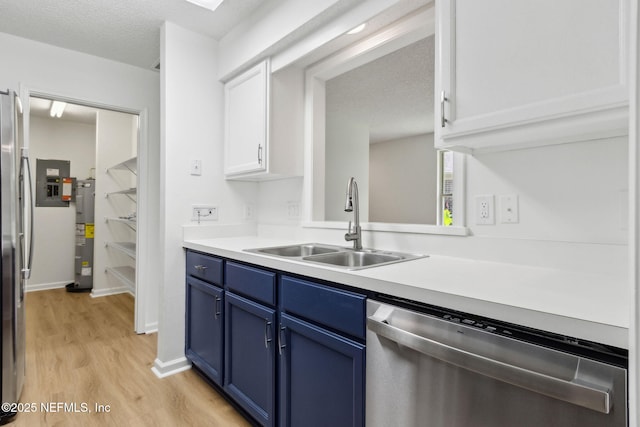 13706 Wm Davis Pkwy, Jacksonville, FL 32224 - kitchen featuring appliances with stainless steel finishes, blue cabinets, light wood finished floors, white cabinets, and light countertops
