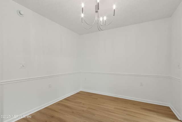 13706 Wm Davis Pkwy, Jacksonville, FL 32224 - spare room featuring a chandelier and light wood-type flooring
