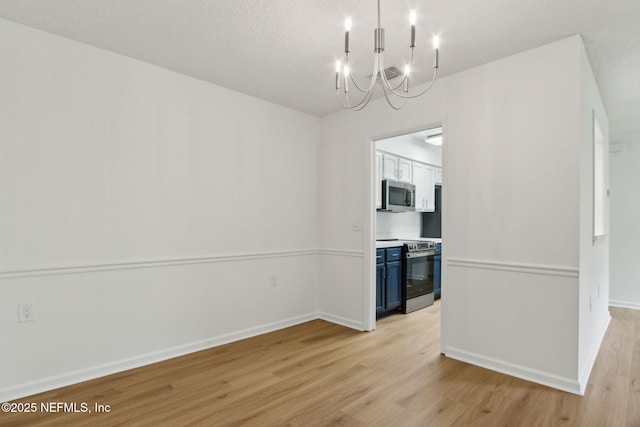 13706 Wm Davis Pkwy, Jacksonville, FL 32224 - unfurnished dining area with light wood finished floors and a chandelier
