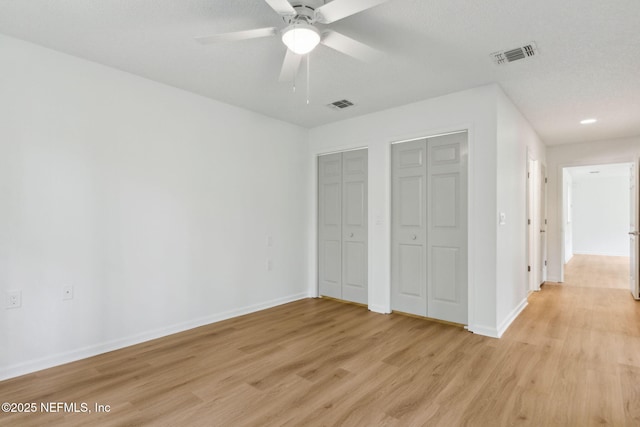 13706 Wm Davis Pkwy, Jacksonville, FL 32224 - unfurnished bedroom featuring multiple closets, light wood-style floors, and ceiling fan