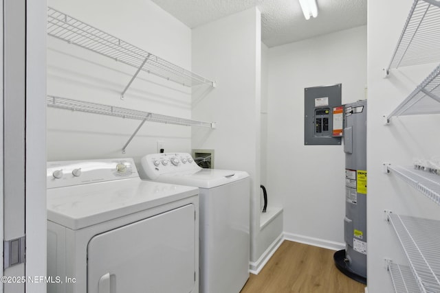 13706 Wm Davis Pkwy, Jacksonville, FL 32224 - laundry area with washing machine and clothes dryer, electric panel, electric water heater, and light wood-type flooring