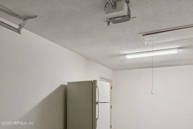 13706 Wm Davis Pkwy, Jacksonville, FL 32224 - garage featuring freestanding refrigerator and a garage door opener
