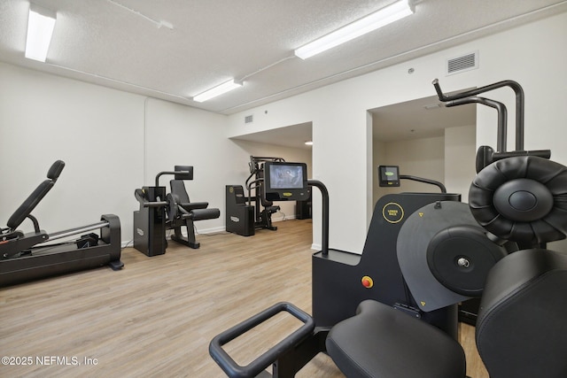 13706 Wm Davis Pkwy, Jacksonville, FL 32224 - exercise room featuring light wood finished floors and a textured ceiling