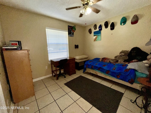 205 Harbor Dr, Palatka, FL 32177 - bedroom with light tile patterned floors, ceiling fan, a textured ceiling, and baseboards