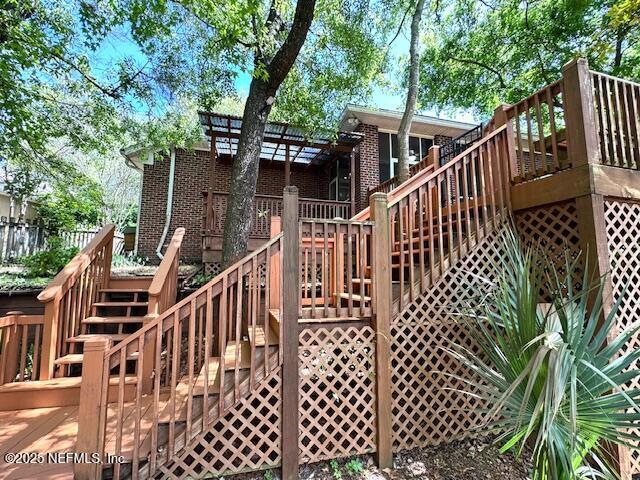 2924 Captiva Bluff Rd S, Jacksonville, FL 32226 - rear view of house featuring stairs, a wooden deck, and brick siding