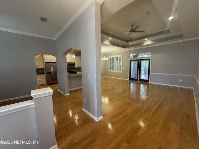 2924 Captiva Bluff Rd S, Jacksonville, FL 32226 - spare room featuring crown molding, visible vents, light wood-style flooring, and ceiling fan with notable chandelier