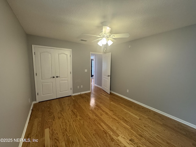 2924 Captiva Bluff Rd S, Jacksonville, FL 32226 - unfurnished bedroom with a closet, wood finished floors, a textured ceiling, baseboards, and visible vents