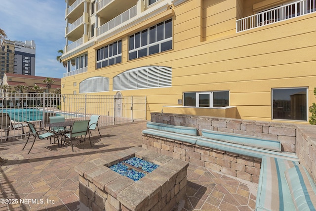 view of patio with fence and an outdoor fire pit