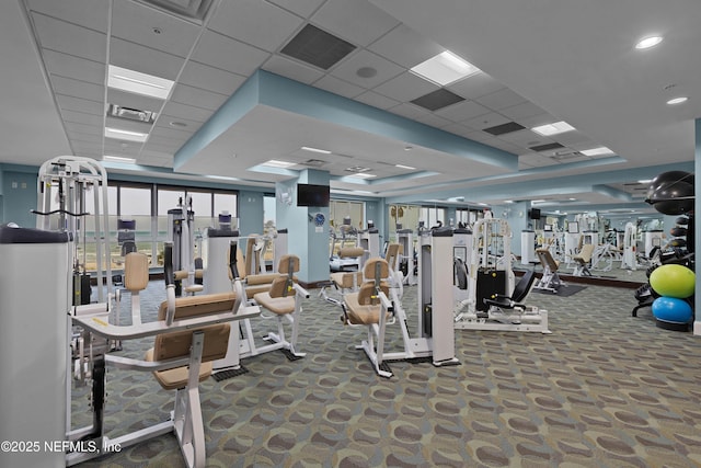 workout area featuring a raised ceiling, visible vents, a paneled ceiling, and carpet flooring