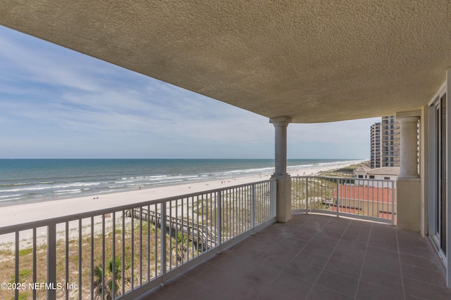 balcony with a view of the beach and a water view