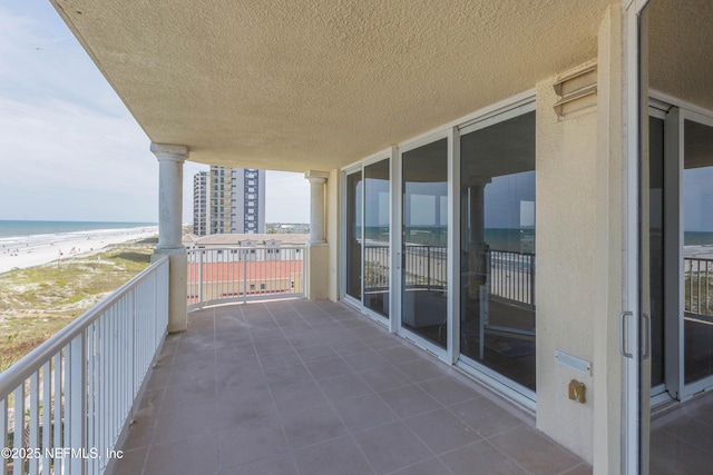 balcony with a beach view and a water view