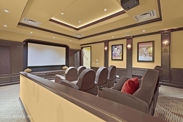 cinema room featuring ornate columns, a decorative wall, crown molding, and a tray ceiling