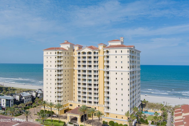 view of property featuring a view of the beach and a water view