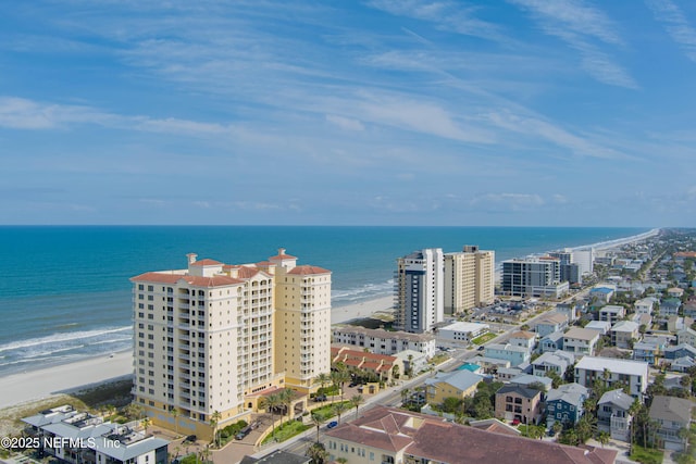 birds eye view of property featuring a beach view and a water view