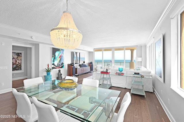 dining area featuring a chandelier, a textured ceiling, crown molding, and dark wood-style floors