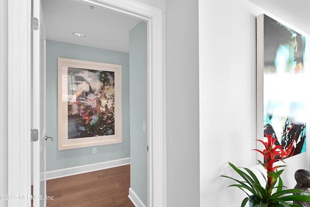 corridor with baseboards and dark wood-style flooring