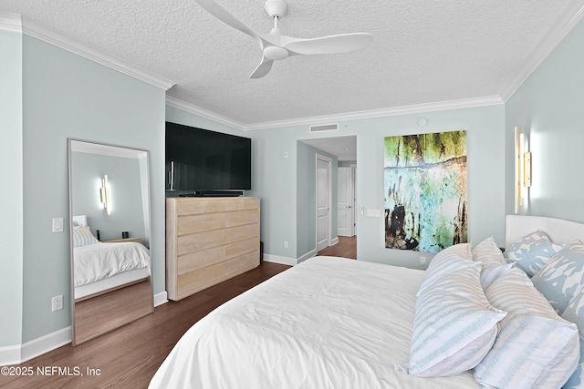 bedroom featuring crown molding, dark wood-style floors, a textured ceiling, and visible vents