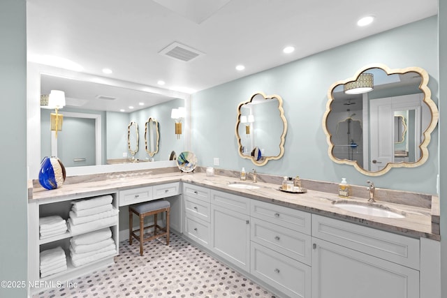 full bathroom featuring double vanity, visible vents, recessed lighting, and a sink