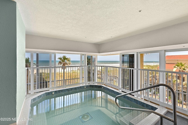 view of pool with a beach view and a water view