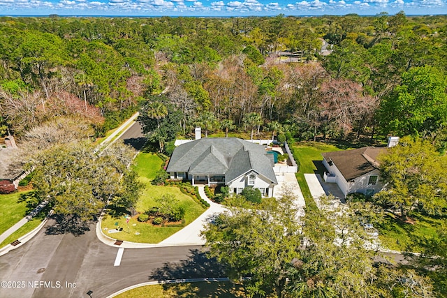 aerial view featuring a wooded view